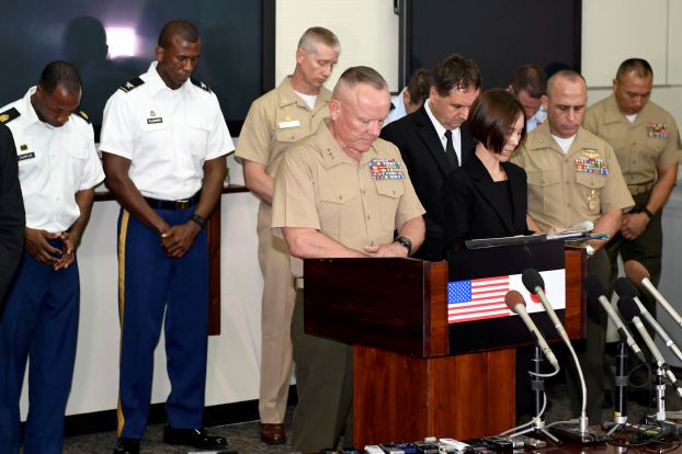Lt. Gen. Lawrence D. Nicholson (C), Commander of the U.S. Marine Forces in Japan, and others observe a moment of silence to mourn the death of a 20-year-old Japanese woman, during a news conference in at Camp Foster in Okinawa Prefecture, Japan, in this photo taken by Kyodo May 28, 2016. Mandatory credit Kyodo/via REUTERS ATTENTION EDITORS - THIS IMAGE WAS PROVIDED BY A THIRD PARTY. EDITORIAL USE ONLY. MANDATORY CREDIT. JAPAN OUT. NO COMMERCIAL OR EDITORIAL SALES IN JAPAN. TPX IMAGES OF THE DAY.