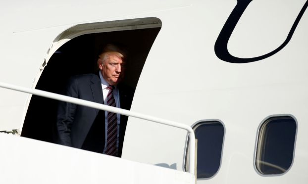 U.S. President Donald Trump steps from Air Force One as he arrives in Morristown to spend the weekend at his golf club in nearby Bedminster, New Jersey, U.S., September 29, 2017. REUTERS/Kevin Lamarque