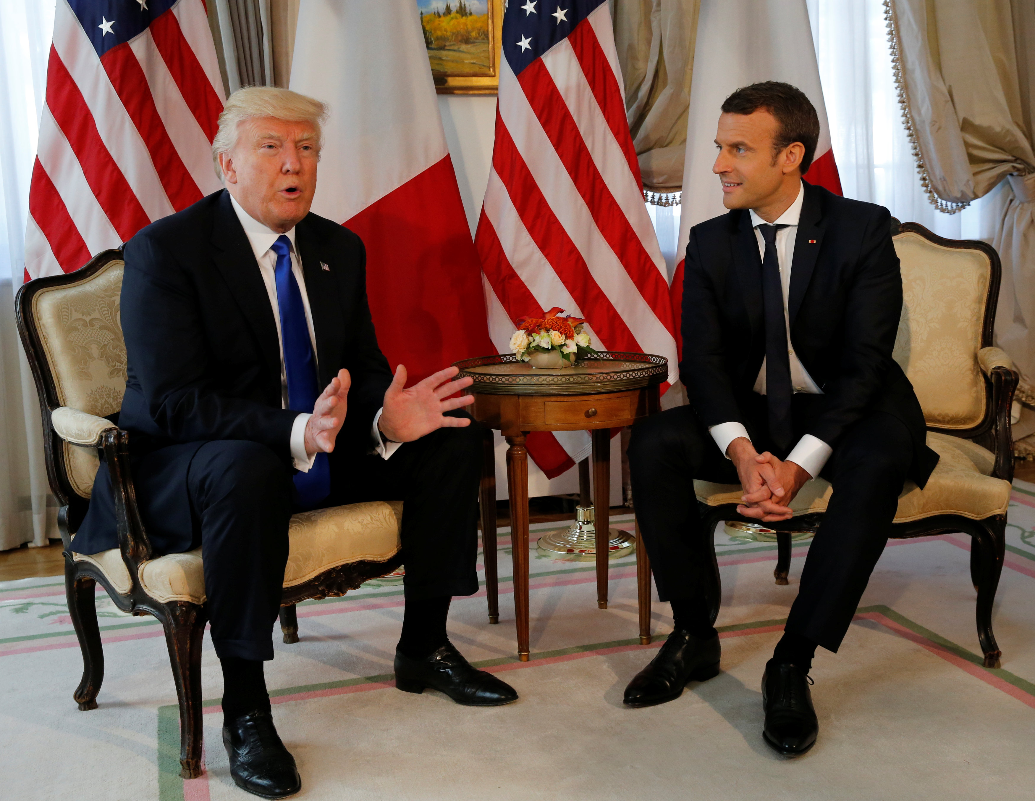 U.S. President Donald Trump (L) gestures beside French President Emmanuel Macron during their meeting before a lunch ahead of a NATO Summit in Brussels, Belgium, May 25, 2017. REUTERS/REUTERS/Jonathan Ernst