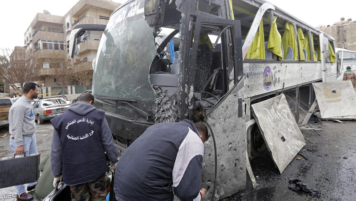 Syrian forensics examine a damaged bus at the scene of a bombing following twin attacks targeting Shiite pilgrims in Damascus' Old City on March 11, 2017.
A roadside bomb detonated as a bus passed and a suicide bomber blew himself up in the Bab al-Saghir area, which houses several Shiite mausoleums that draw pilgrims from around the world, the Syrian Observatory for Human Rights said. / AFP PHOTO / Louai Beshara (Photo credit should read LOUAI BESHARA/AFP/Getty Images)