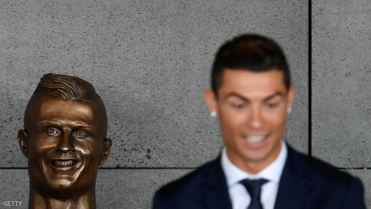 Portuguese footballer Cristiano Ronaldo stands beside a bust presented during a ceremony to rename Madeira's airport in Funchal as "Cristiano Ronaldo", on Madeira island, on March 29, 2017. Airport of Madeira, the birthplace of Portuguese footballer Cristiano Ronaldo, was renamed today in honor of the quadruple Ballon d'or and captain of the Portuguese team sacred European champion last summer. / AFP PHOTO / FRANCISCO LEONG (Photo credit should read FRANCISCO LEONG/AFP/Getty Images)