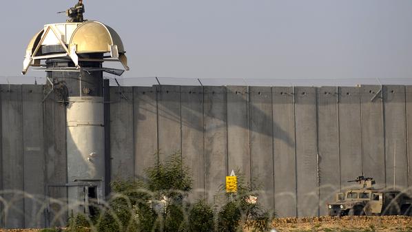 An Israeli soldier mans a watch tower equipped with a machine gun on the north side of the border with the Gaza Strip on December 26, 2009. Israeli forces killed three Palestinians as they tried to cross the security barrier from the Gaza Strip into Israel, a Palestinian medic said. AFP PHOTO/DAVID BUIMOVITCH (Photo credit should read DAVID BUIMOVITCH/AFP/Getty Images)