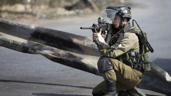 An Israeli solder takes aim, during clashes with Palestinians near Ramallah, West Bank, Tuesday, Oct. 20, 2015. U.N. Secretary-General Ban Ki-moon called for calm during a surprise visit to Jerusalem on Tuesday ahead of meetings with Israeli and Palestinian leaders, in a high-profile gambit to bring an end to a monthlong wave of violence. (AP Photo/Majdi Mohammed)