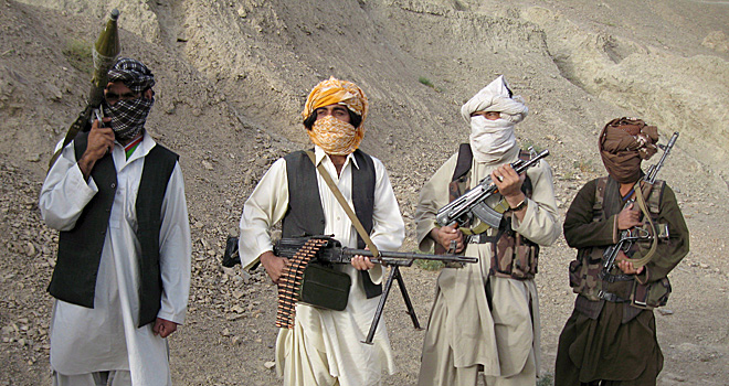 epa01514525 A picture made available on 09 October 2008 shows Taliban militants standing guard as their spokesman Zabiullah Mujahid (not in picture) talks with a journalist in the mountains of Afghanistan volatile Helmand province a hotbed of Taliban militants, 07 October 2008. The Taliban spokesman said that the ongoing mediation of Saudi Arabia for resolving the conflicts between Taliban and Afghan government is being done without the consent of Taliban's supreme leader Mullah Omar and they will not support the talks until 70,000 international forces withdraw from the country. Following two years of strategic stalemate in the military fronts, and mounting public opinion pressure in western countries which have soldiers in Afghanistan, to end the war, Afghan and western officials have joined a chorus to call for peace with militants. EPA/STRINGER