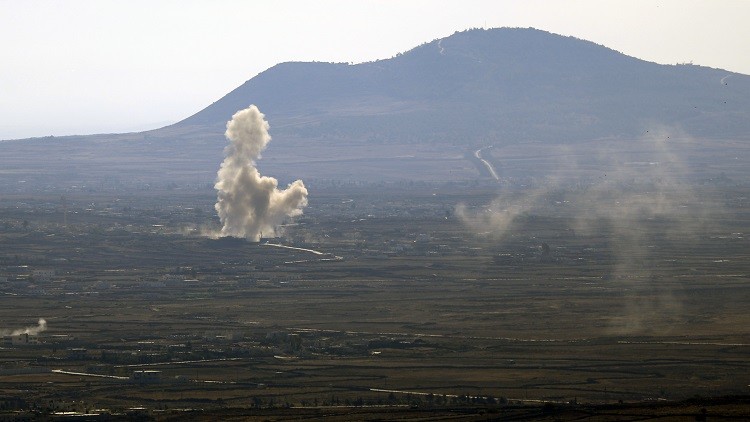A picture taken on October 21, 2014 from the Israeli-annexed Golan Heights near the Quneitra border crossing with Israel shows smoke billowing from buildings in Syrian territory, following fighting between forces loyal to Syrian President Bashar Assad and rebel fighters. AFP PHOTO / JALAA MAREY
