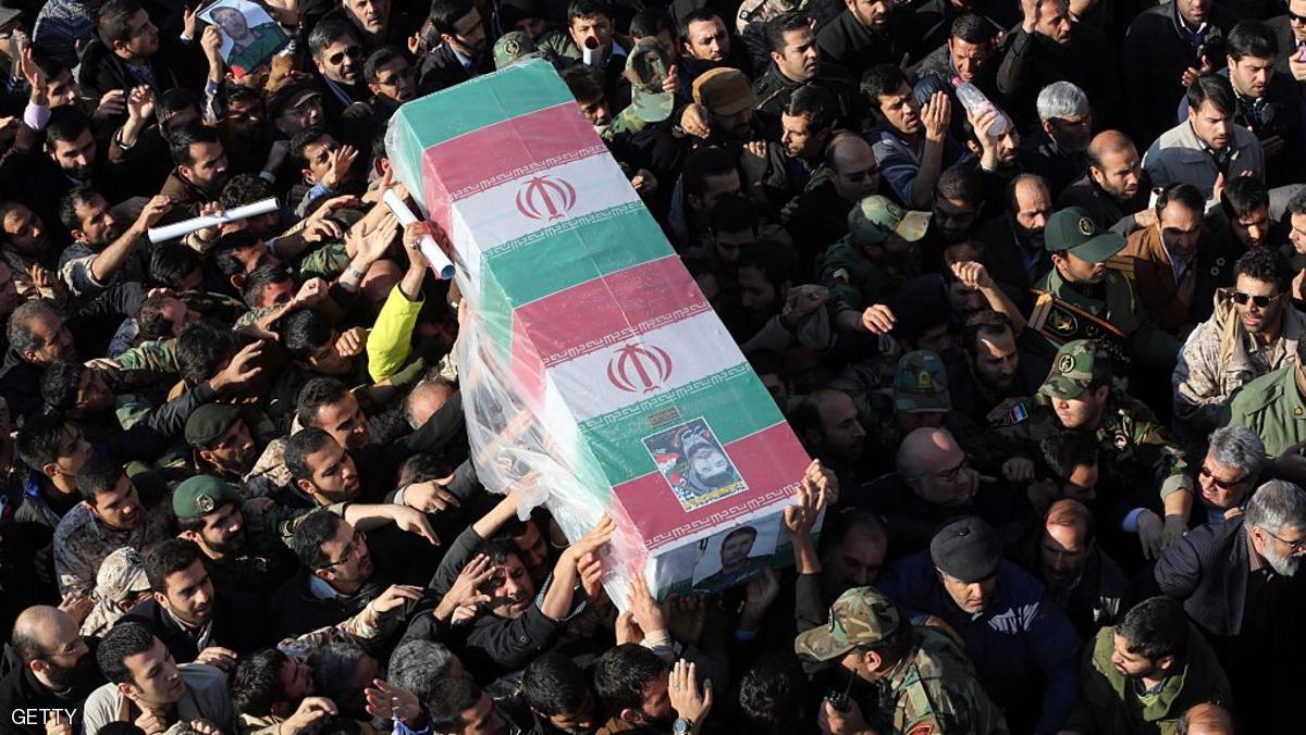 Iranian mourners carry the coffin of Brigadier General Mohammad Ali Allahdadi, a commander of the Islamic republic's Revolutionary Guards killed in an Israeli air strike on the weekend on Syria, during his funeral procession in Tehran on January 21, 2015. A public memorial service was held in the Iranian capital for Allahdadi, who was killed along with five other Iranians and six Hezbollah fighters in an Israeli air raid on the Syrian-controlled side of the Golan Heights targeting forces from Lebanon's Hezbollah on January 18. AFP PHOTO / ATTA KENARE (Photo credit should read ATTA KENARE/AFP/Getty Images)