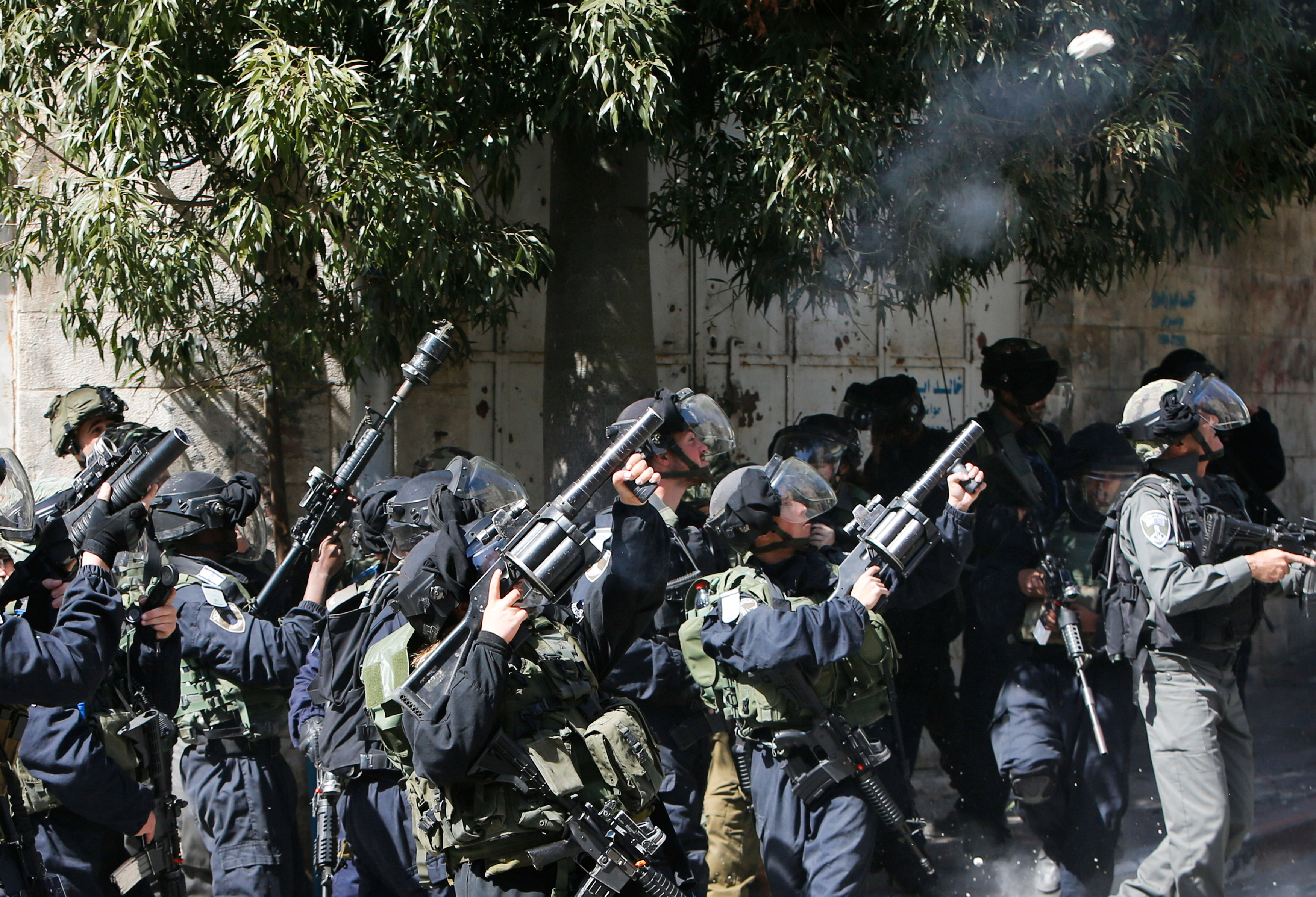 A stone is thrown at Israeli troops as they fire tear gas towards protesters during clashes at a protest by Palestinians and foreign activists in the West Bank city of Hebron February 24, 2017. REUTERS/Mussa Qawasma