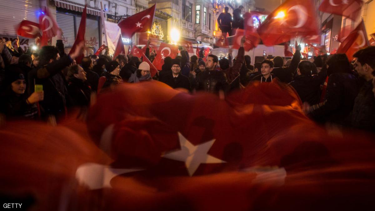 ISTANBUL, TURKEY - MARCH 12: Protesters hold a large Turkish flag as they sing songs and chant slogans outside the Dutch Consulate on March 12, 2017 in Istanbul, Turkey. Protesters gathered outside the consulate after the Turkish foreign minister, who was scheduled to speak in the Dutch city of Rotterdam, was refused entry and his plane banned from landing. In response to the action Turkish President Recep Tayyip Erdogan speaking at a referendum rally described the Dutch as " Nazi remnants and fascists" (Photo by Chris McGrath/Getty Images)