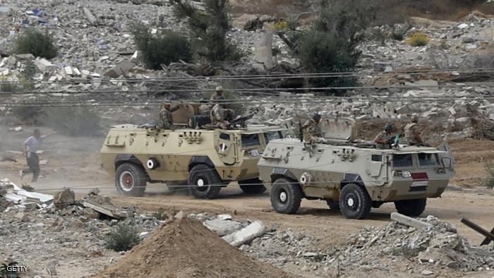 Egyptian soldiers watch during a military operation in the Egyptian city of Rafah, near the border with the southern Gaza Strip on October 30, 2014, as Egypt began setting up a buffer zone along the border with the Hamas-run territory to prevent militant infiltration and arms smuggling following a wave of deadly attacks. The move, which is set to result in the demolition of hundreds of homes, comes after a suicide bombing in the Sinai Peninsula killed at least 30 soldiers last week. AFP PHOTO/MOHAMMED ABED (Photo credit should read MOHAMMED ABED/AFP/Getty Images)