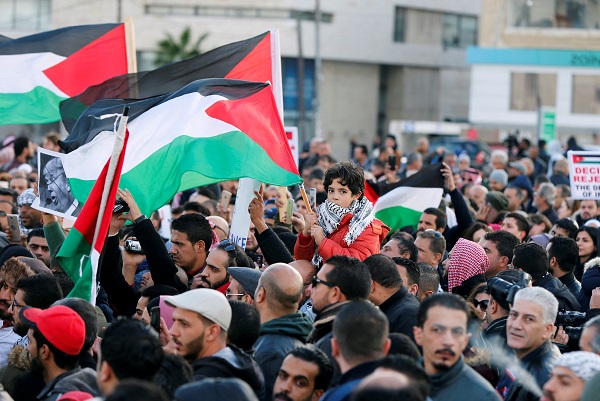 Protesters hold the Palestinian flags during a protest near the American Embassy in Amman, Jordan December 7, 2017. REUTERS/Muhammad Hamed