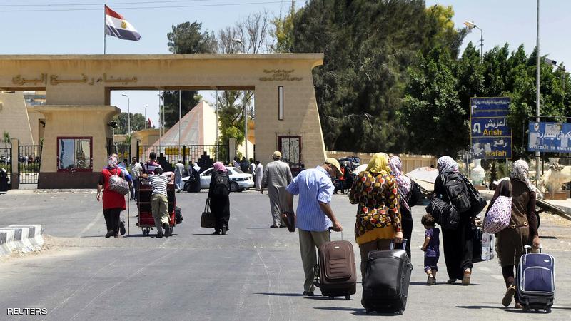 Travellers walk with their belongings towards the Egyptian side of the Rafah border crossing on August 10, 2012. Egypt temporarily reopened the Rafah border crossing into the Gaza Strip, which was closed after militants attacked troops on August 18, and killed 16 soldiers. AFP PHOTO/STR (Photo credit should read -/AFP/GettyImages)