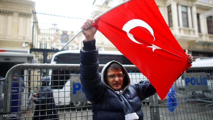 A demonstrator holds a Turkish flag during a protest in front of the Dutch Consulate in Istanbul, Turkey, March 12, 2017. REUTERS/Osman Orsal